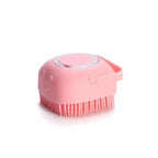Pink grooming brush on a white background