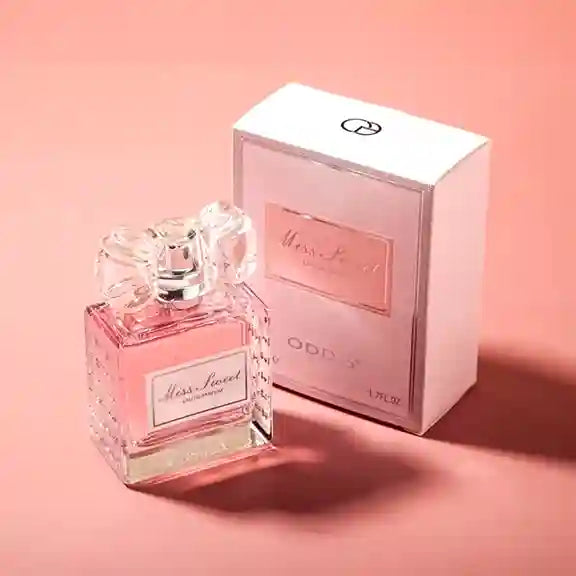 Pink perfume bottle and packaging on a matching pink background