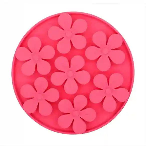 Pink silicone mold with flower shapes on a white background