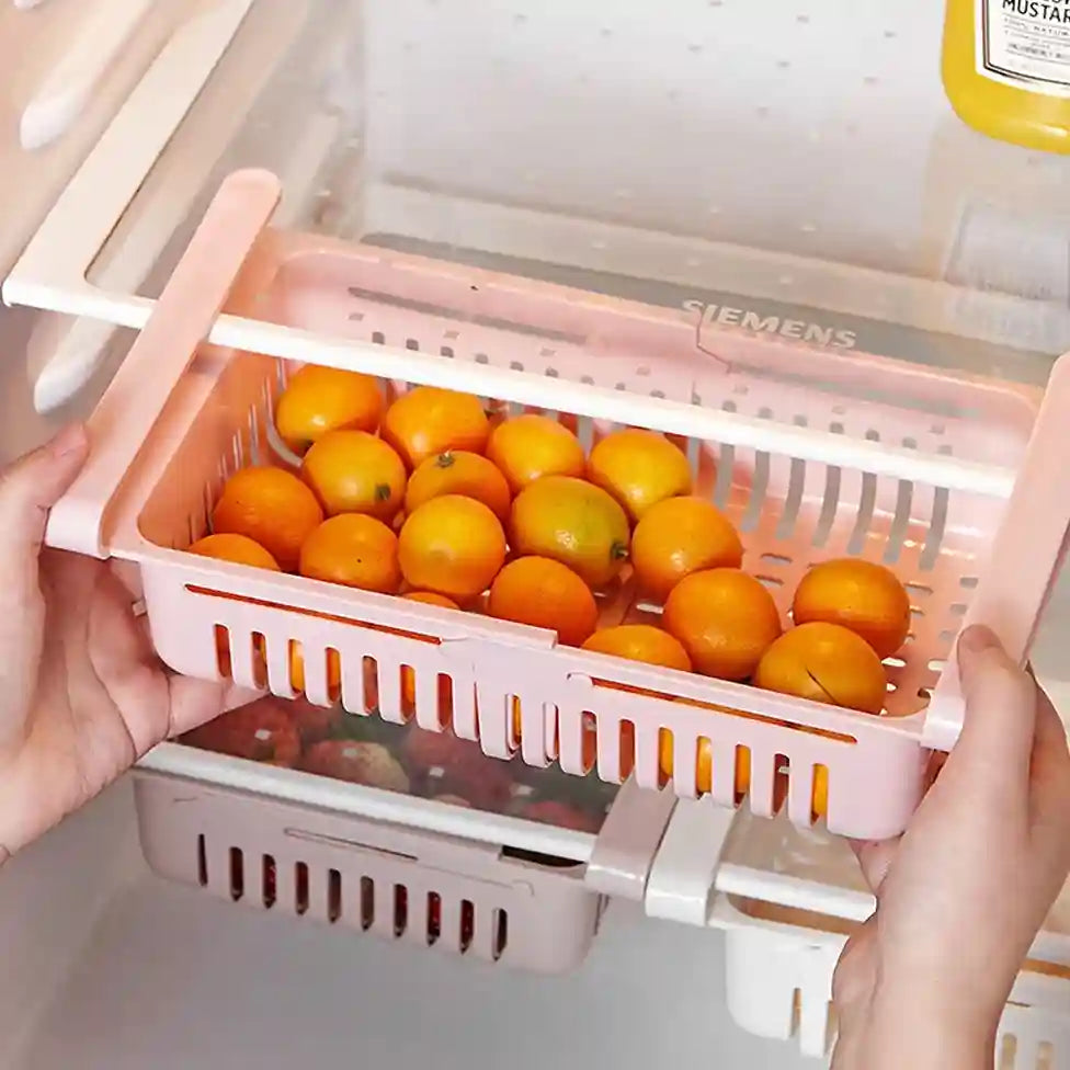 Pink vegetable drawer extension with oranges inside a refrigerator, featuring Siemens branding.