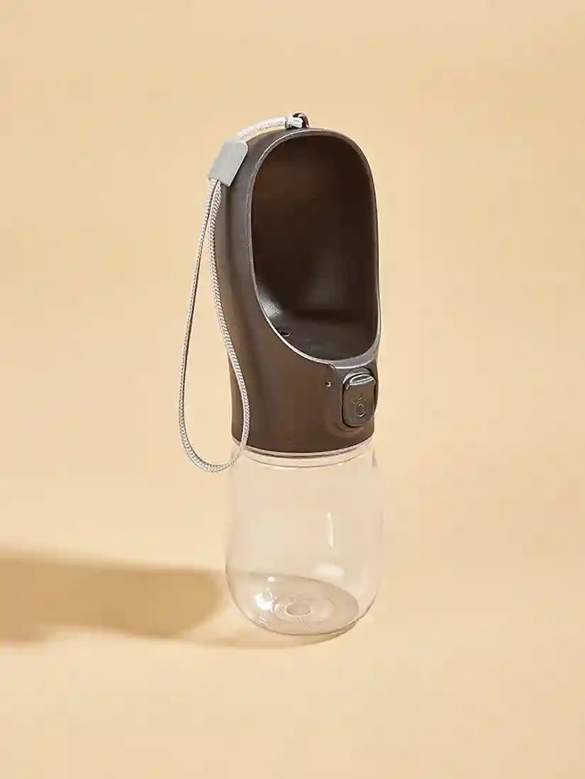 Portable pet water bottle with brown top and clear base on a beige background