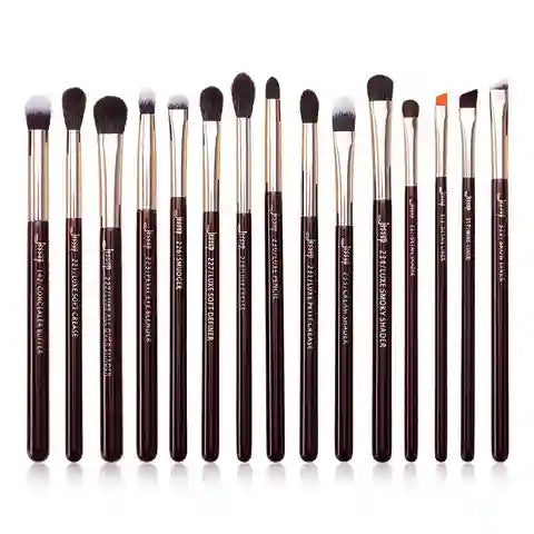Set of 15 makeup brushes with brown handles and black bristles on a white background
