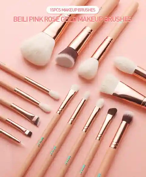 Set of 15 pink rose gold makeup brushes on a pink background