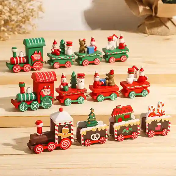 Set of Christmas-themed miniature trains on a wooden surface