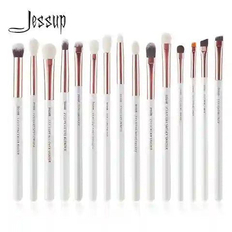 Set of Jessup makeup brushes with white handles and rose gold ferrules on a white background.