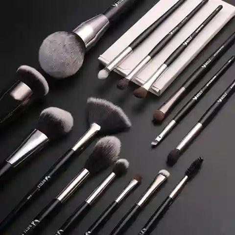 Set of makeup brushes on a dark surface
