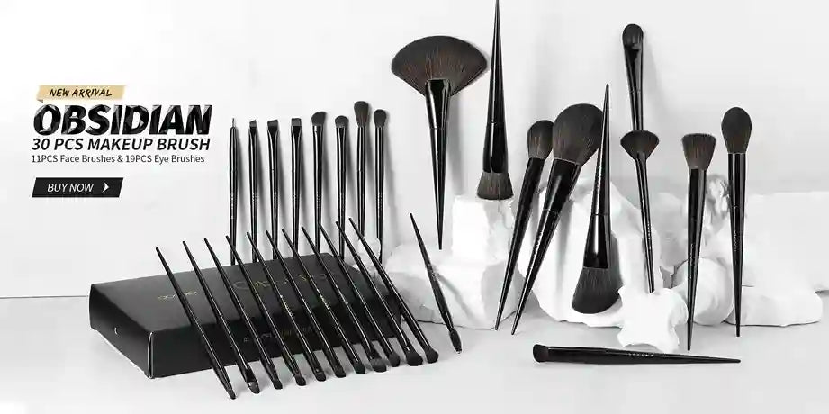 Set of makeup brushes with a black holder on a white background, featuring the brand 'Obsidian'.