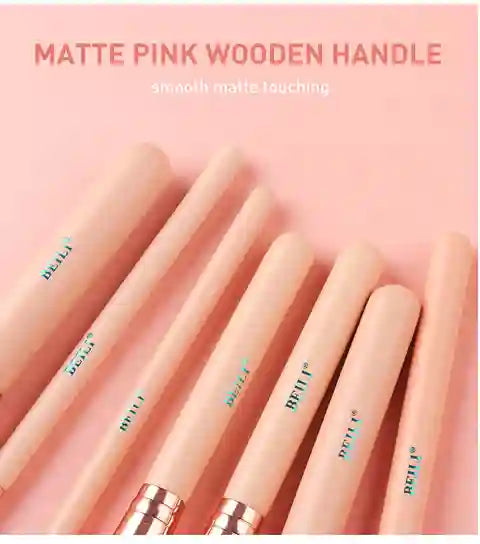 Set of matte pink wooden handles with visible brand name on a pink background