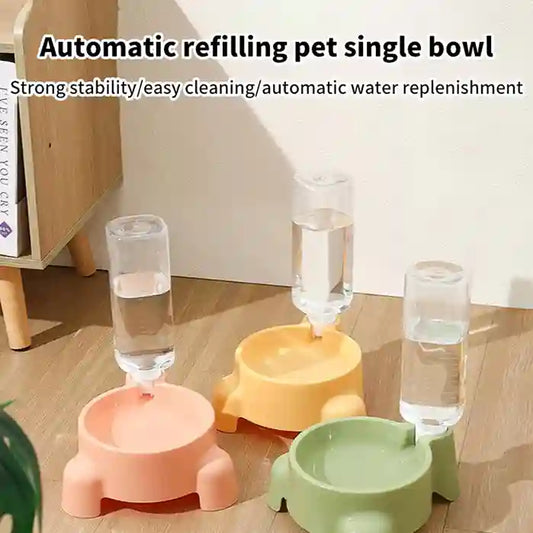 Three colorful pet water bowls with automatic refilling system on a wooden floor.