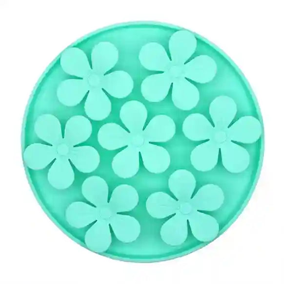 Turquoise silicone mold with flower shapes on a white background