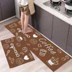 Two brown kitchen mats with coffee-themed designs on a floor in a kitchen.