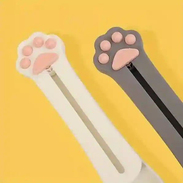 Two cat paw-shaped clips on a yellow background