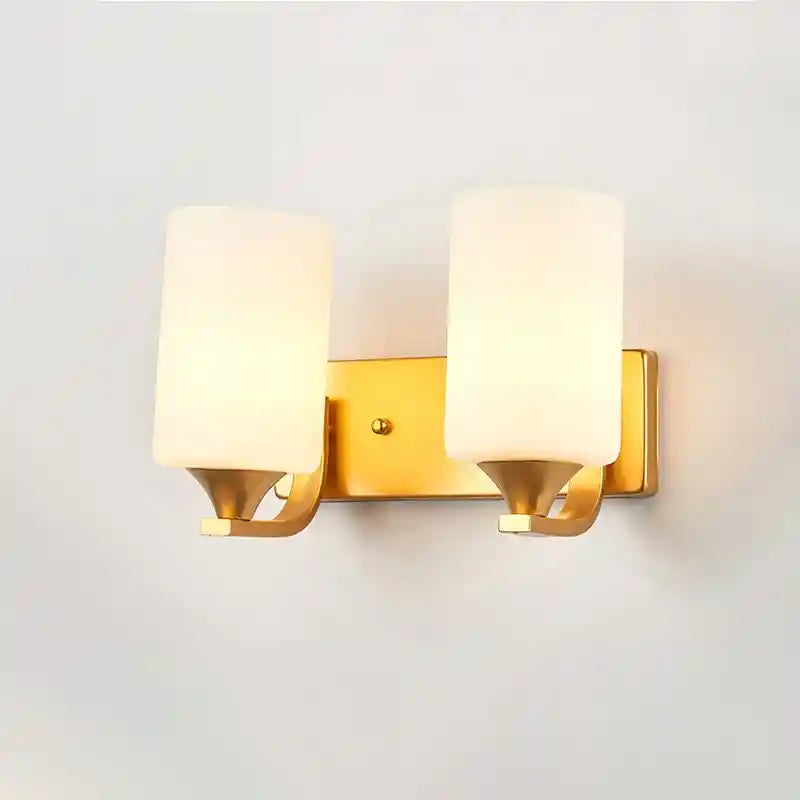 Wall-mounted lamp with gold frame and white glass shades on a light gray background