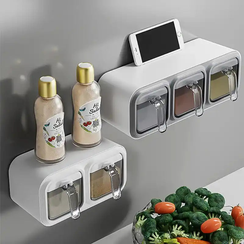 Wall-mounted spice rack with seasoning containers and a smartphone holder, next to a salad.