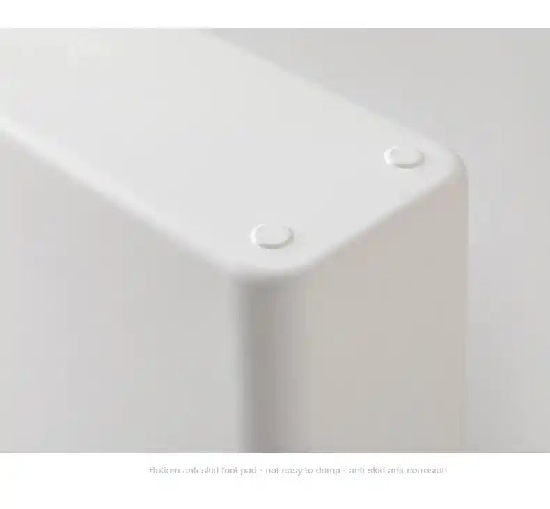 White corner bracket with anti-slip foot pad on a light gray background