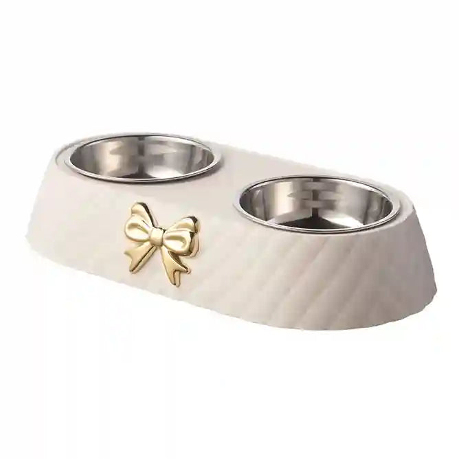White pet bowl with gold bow design on a white background