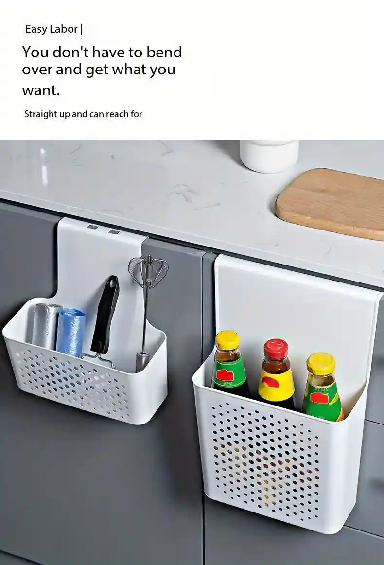 White storage baskets attached to a kitchen cabinet with bottles and kitchen items.