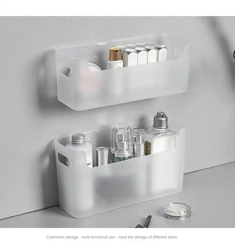 White wall-mounted storage basket with cosmetic items on a light gray surface.