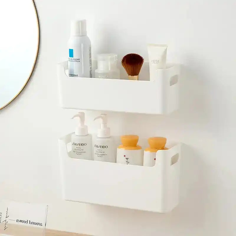 White wall-mounted storage shelf with skincare products against a light gray wall.