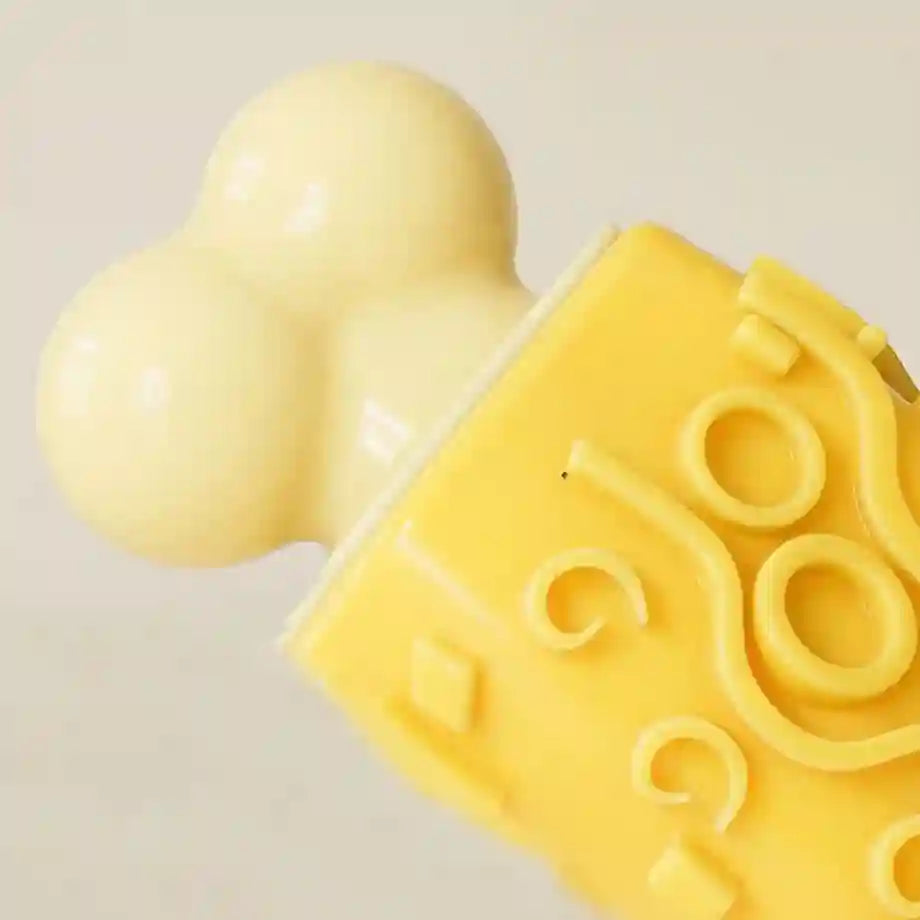 Yellow silicone mold shaped like a dog with a heart on a beige background