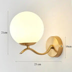 Gold wall lamp with dimensions indicated on a light gray background