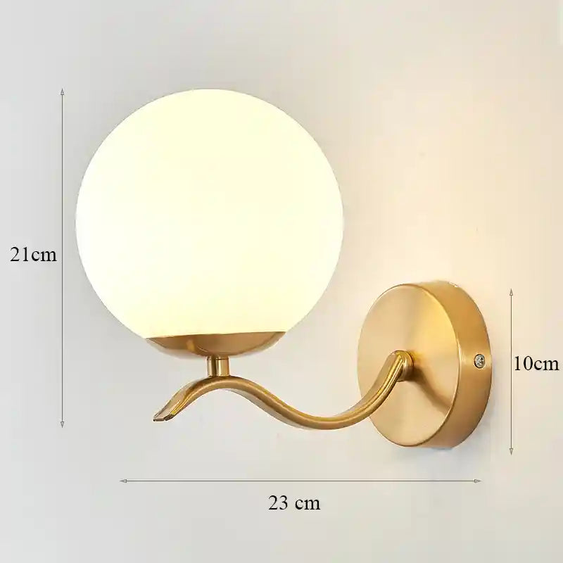 Gold wall lamp with dimensions indicated on a light gray background